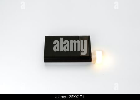 LED flashlight from Power Bank using USB. Convenient flashlight and black power bank on a white background Stock Photo