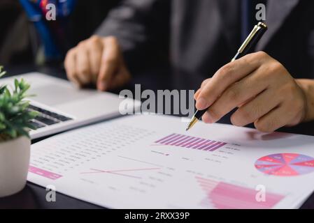 Businessman analyzing business planning, strategy, marketing and financial reports Hand Holding File, Checking reports, and reviewing business statist Stock Photo