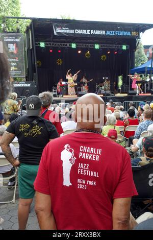 Afro-American man listening to an all female band performing at the Charly Parker Festival in Tompkins Square Park,East Village, Manhattan, New York, Stock Photo