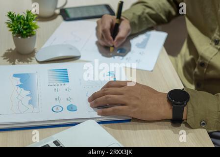 Business person working with financial documents analyzing. business investment information, financial and tax system planning and business strategies Stock Photo
