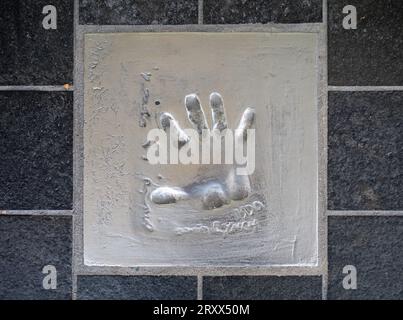 The handprint from famous American filmmaker, screenwriter, artist, musician, and actor David Lynch set into the pavement of The Allée des Étoiles (Av Stock Photo