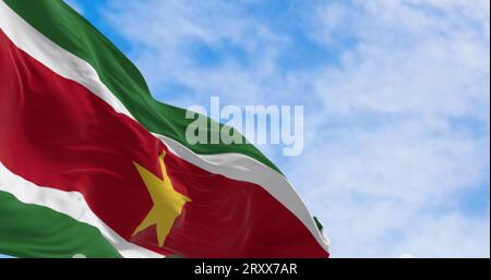 Suriname national flag waving in the wind on a clear day. 5 horizontal bands: green, white, red, white, green, yellow star in the center. 3D illustrat Stock Photo