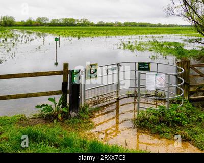 Footpath stile into North Meadow in Cricklade during winter floods - Wiltshire UK Stock Photo