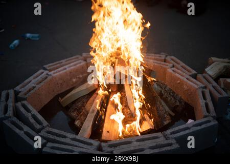 Large bonfire on street. Bonfire in evening. Concrete blocks