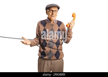 Elderly man man tangled in a cable from a vintage rotary phone isolated on white background Stock Photo