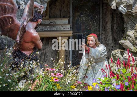 Sculpture of the devil and St Anthony of Padua at grotto in the village Crupet, Assesse, province of Namur, Belgian Ardennes, Wallonia, Belgium Stock Photo