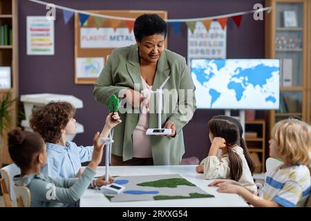 School teacher explaining children how wind turbine works Stock Photo ...