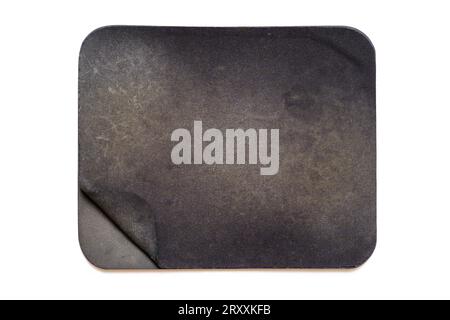 Top view of an old and heavily used mouse pad isolated on white background. Stock Photo