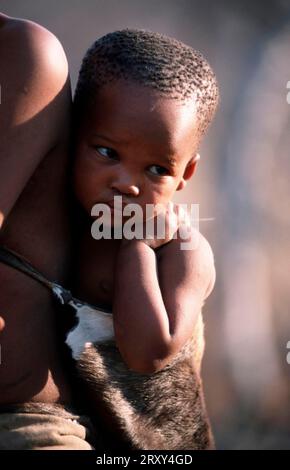 Bushman child on mother's back, africa, San, Bushmen, Bushmen, people, people, children, children, Kalahari, Namibia, Bushman child on mother's back Stock Photo