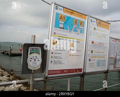 Punta Sabbioni, Cavallino-Treporti, Veneto, Italy, Information boards (in English) and a ticket validation machine at the port Stock Photo