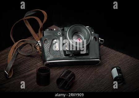 Old film SLR camera for 35 mm film in a worn case, top view Stock Photo
