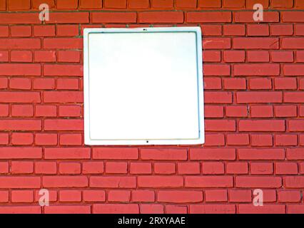 Dark red brick wall texture pattern with empty white background in the middle Stock Photo