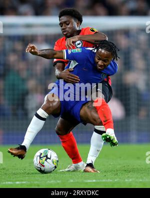 Chelsea's Raheem Sterling and Brighton and Hove Albion's Tariq Lamptey battle for the ball during the Carabao Cup third round match at Stamford Bridge, London. Picture date: Wednesday September 27, 2023. Stock Photo