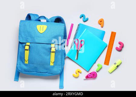 Stylish school backpack with different stationery on grey background Stock Photo