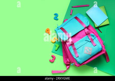 Stylish school backpack and different stationery on green background Stock Photo