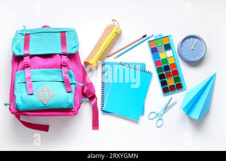 Stylish school backpack and different stationery on white background Stock Photo