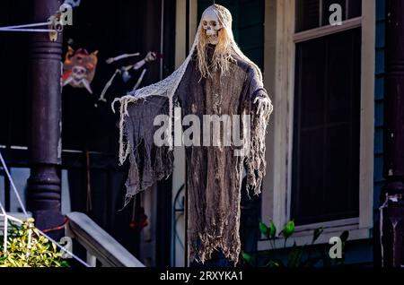 A skeleton hangs on the front porch of a house, Sept. 23, 2023, in Mobile, Alabama. Many people have already started decorating for Halloween. Stock Photo