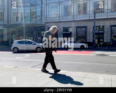 August 16, 2023, San Francisco, California, USA: A homeless man walks past Macyâ€™s Department Store in Union Square in San Francisco, California on Wednesday August 16, 2023. Many retailers are citing homeless problems and other challenges of operating in Downtown San Francisco and contemplating whether to remain open. (Credit Image: © David G. McIntyre/ZUMA Press Wire) EDITORIAL USAGE ONLY! Not for Commercial USAGE! Stock Photo