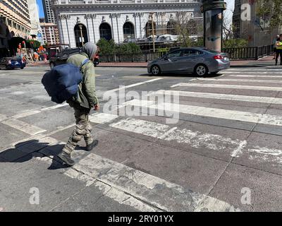 August 16, 2023, San Francisco, California, USA: A homeless man crosses the street on Market Street in San Francisco, California on Wednesday August 16, 2023. Many retailers are citing homeless problems and other challenges of operating in Downtown San Francisco and contemplating whether to remain open. (Credit Image: © David G. McIntyre/ZUMA Press Wire) EDITORIAL USAGE ONLY! Not for Commercial USAGE! Stock Photo