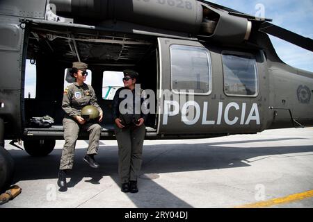 Two Colombian police helicopter polots sit on the door of a UH60 Black Hawk helicopters during an event at the CATAM - Airbase in Bogota, where the United States of America embassy in Colombia gave 3 Lockheed Martin UH60 Black Hawks to improve the antinarcotics operations, on September 27, 2023. Photo by: Chepa Beltran/Long Visual Press Stock Photo