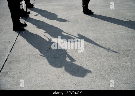 The shadow of Colombian police helicopter pilots casts over the apron during an event at the CATAM - Airbase in Bogota, where the United States of America embassy in Colombia gave 3 Lockheed Martin UH60 Black Hawks to improve the antinarcotics operations, on September 27, 2023. Photo by: Chepa Beltran/Long Visual Press Stock Photo