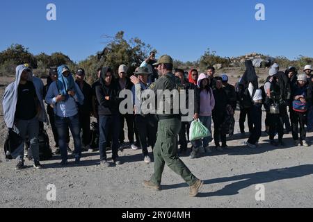 September 26, 2023, Jacumba Hot Springs, California, USA: Large groups of asylum-seekers arrive to a makeshift camp near the Jacumba Hot Springs desert, an unincorporated area, following their crossing from Mexico into the United States in east San Diego, California on Tuesday, September 26, 2023. Migrants continue to arrive to desert campsites along the US-Mexico border, as they await to be processed by US Border Patrol in tents made from tree branches. (Credit Image: © Carlos A. Moreno/ZUMA Press Wire) EDITORIAL USAGE ONLY! Not for Commercial USAGE! Stock Photo