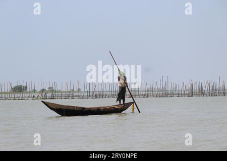 Traditional boatman rowing boat at chilka lake Stock Photo