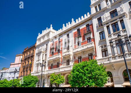 Sevilla, Spain - April 10, 2023: Buildings, stores and people in Calle San Fernando, central Seville. Stock Photo