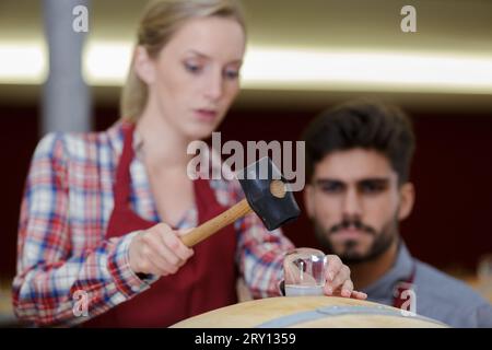two concentrated wine house workers in cellar Stock Photo