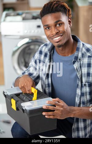 portrait of a washing-machine serviceman holding a toolbox Stock Photo