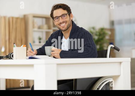 smiling young man in wheelchair Stock Photo