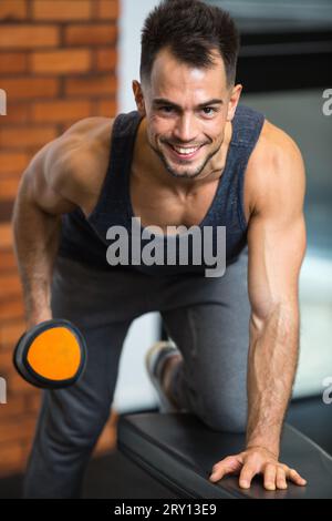 happy man doing exercises with dumbbell in the fitness club Stock Photo