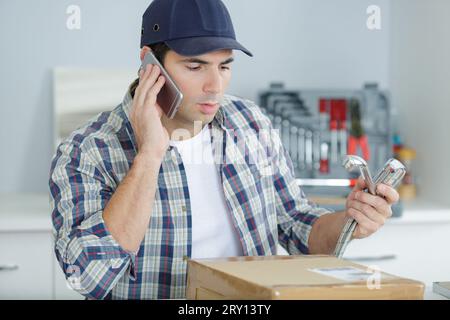 technician doing meter reading using mobilephone Stock Photo