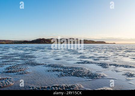 Looking out and accrose the exposed beach during sunrise and a low tide at Hearson Cove near Karratha and Dampier Western Australia, Australia. Stock Photo