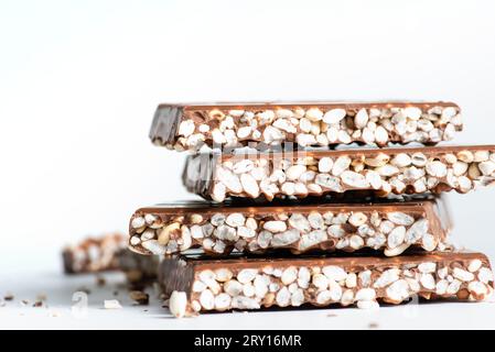 Chunks of milk chocolate with puffed rice isolated on white background ...