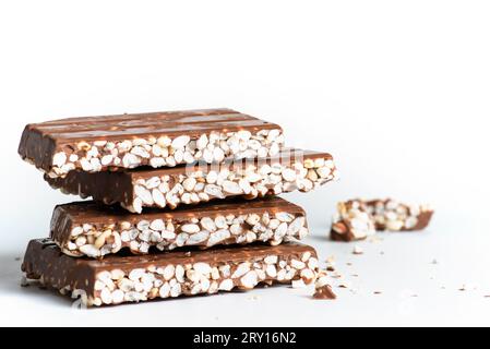 Chunks of milk chocolate with puffed rice isolated on white background ...