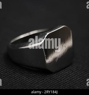 classic square cut antique metallic platinum ring isolated in a black background in closeup Stock Photo