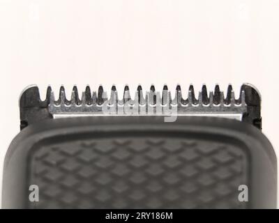 closeup macro shot of the razor teeth of hair clipper or trimmer blade used for shaving isolated in a white background Stock Photo
