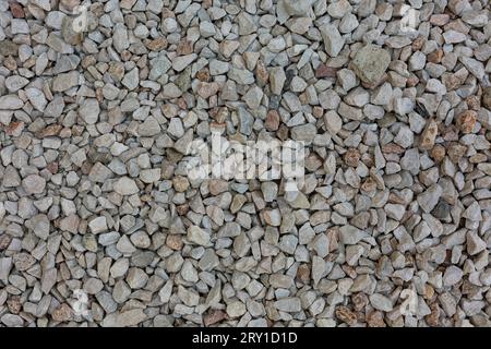 Close view of grey irregular crushed stone. High quality photo Stock Photo