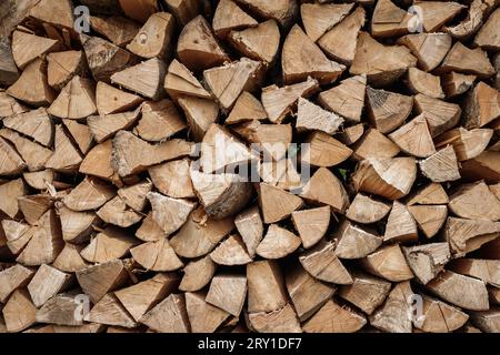 Stacked firewood background. Drying of chopped timber wood. Woodpile is ready for winter season Stock Photo