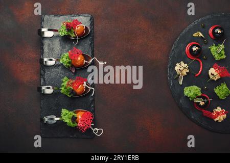 Molecular modern cuisine galantine duck in spoons on stone and rusty background. Top view. Stock Photo