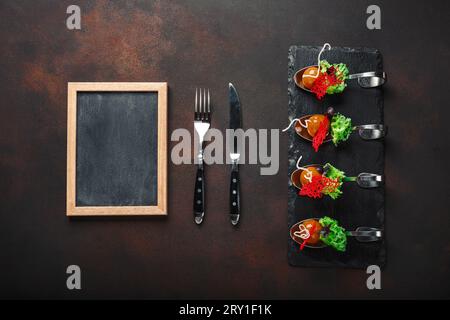 Molecular modern cuisine galantine duck in spoons on stone and rusty background. Top view with space for your text. Stock Photo