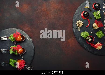 Molecular modern cuisine galantine duck in spoons on stone and rusty background. Top view. Stock Photo