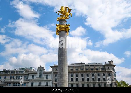 View of the gold sculpture, statue of Saint George, on top of a marble column in Independence Square. In Tbilisi, Georgia, Europe. Stock Photo