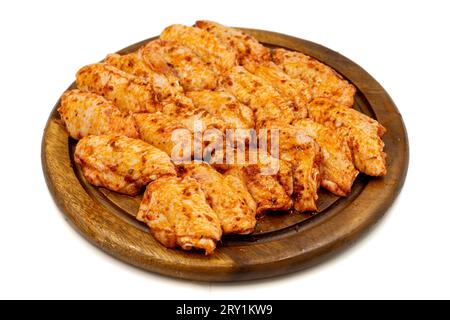 Chicken wings with sauce isolated on white background. Raw chicken wings with herbs and spices Stock Photo