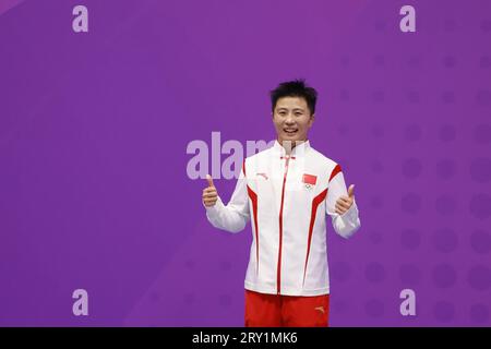 HANGZHOU, CHINA - SEPTEMBER 28, 2023 - Li Yueyao of China poses on the winner's podium during the women's 52kg Martial Arts Kick-boxing competition at Stock Photo