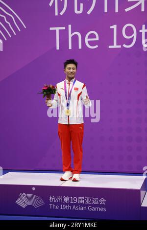 HANGZHOU, CHINA - SEPTEMBER 28, 2023 - Li Yueyao of China poses on the winner's podium during the women's 52kg Martial Arts Kick-boxing competition at Stock Photo