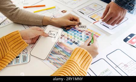 team of UI UX web designer are working together to develop mobile responsive websites with UI UX front end designer previews Stock Photo