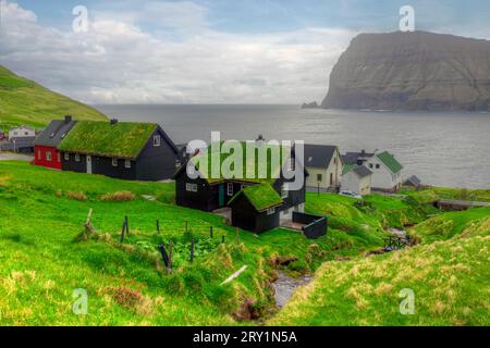 The village of Mikladalur on the island of Kalsoy with its statue of the Seal Woman, Faroe Islands. Stock Photo