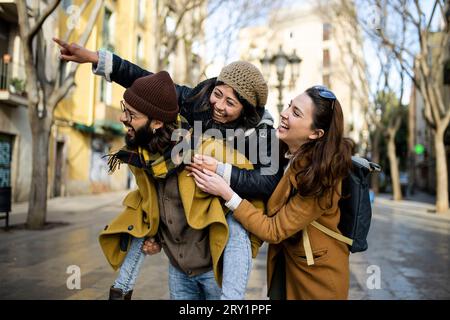 three happy young friends having fun in the city. Multiracial group smiling and looking at camera. Travel concept Stock Photo